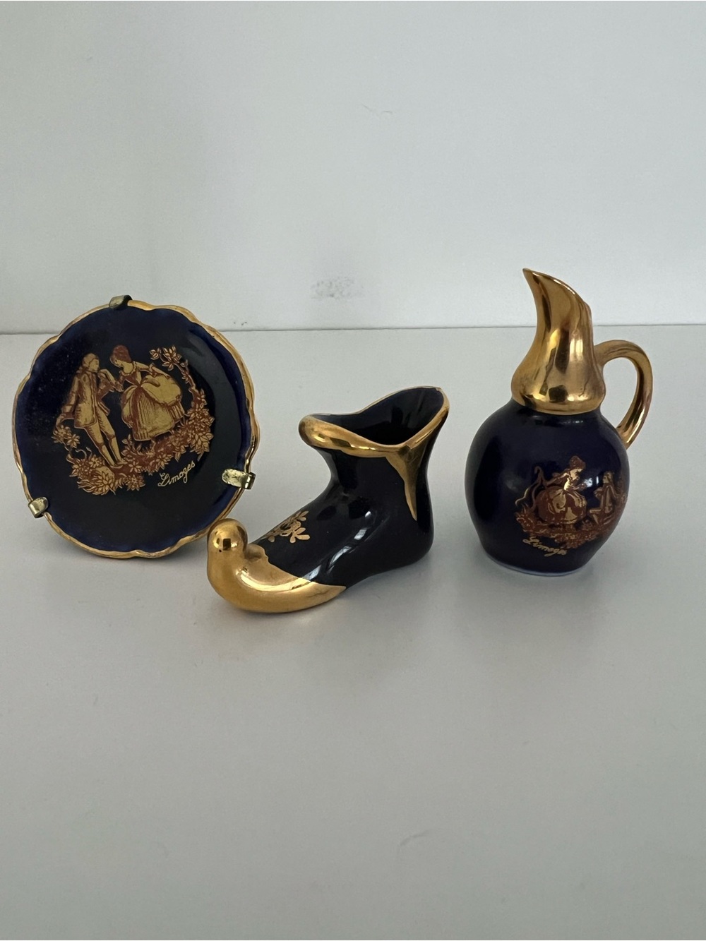Vintage Limoges miniature figurines. Cobalt blue with gold trim.